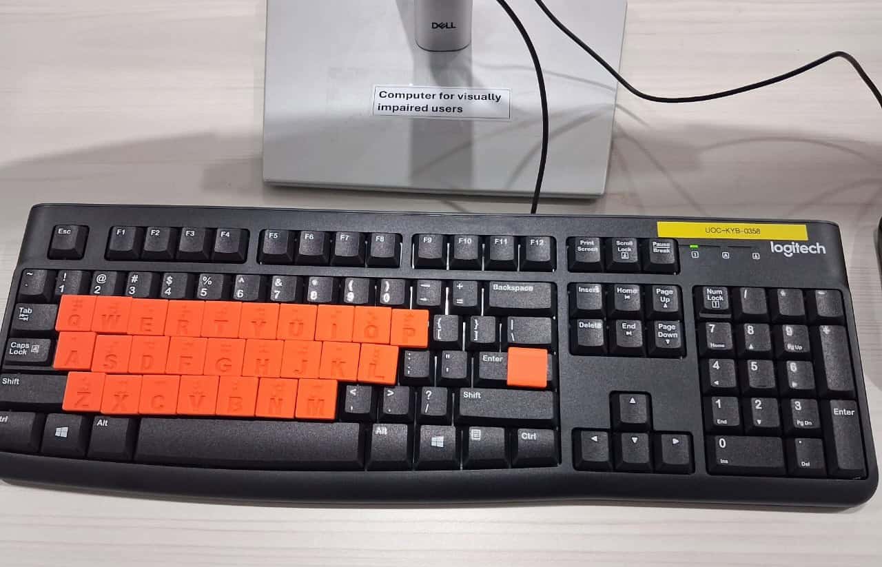 Braille-adapted keyboard at a workstation labelled for visually impaired users