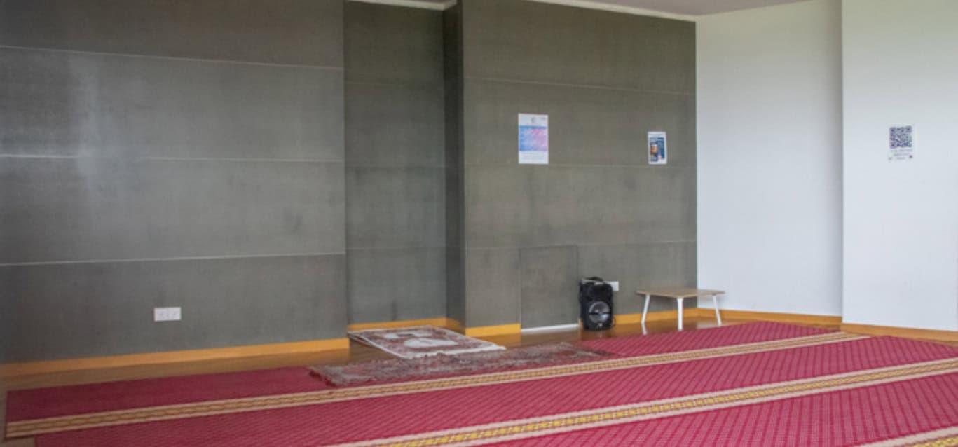 Surau prayer area with prayer mats