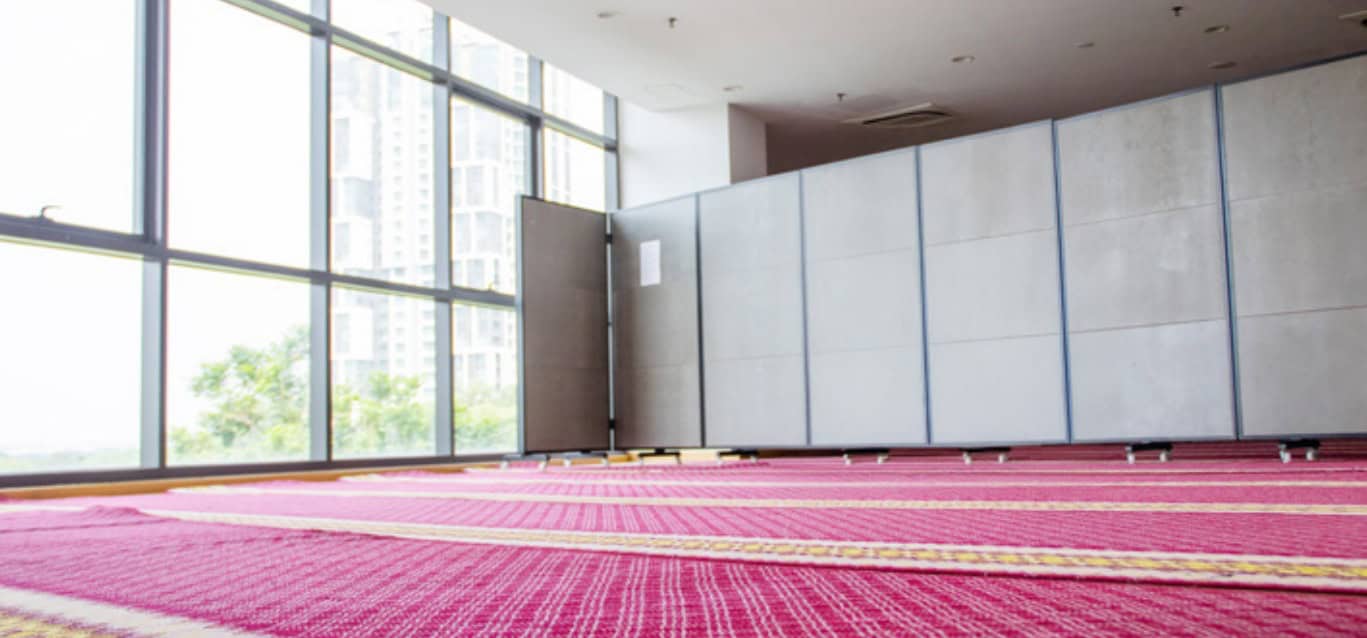 Surau prayer area beside windows and storage cabinets